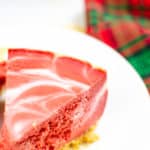 Instant Pot Cheesecake on white plate with red and green plaid napkin