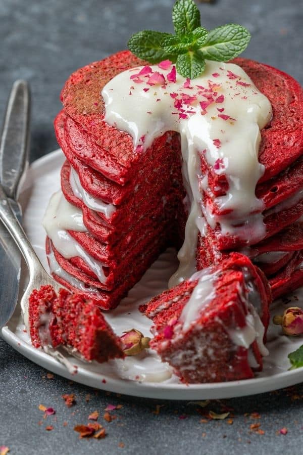 Stack of Red Velvet pancakes with a large bite taken out