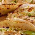 a plate of tilapia fish tacos with lettuce