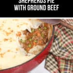 Shepherd's pie recipe with ground beef in a red dish, topped with creamy mashed potatoes, featuring peas and carrots. A wooden spoon and checkered cloth are nearby, ready for the perfect cozy meal.
