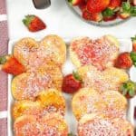 Plate of air fryer pop tarts with fresh strawberries in the background