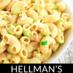 A bowl of classic Hellman's macaroni salad with egg, featuring elbow pasta and diced vegetables.