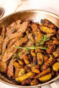 Skillet Steak and Potatoes in a saute pan with herbs