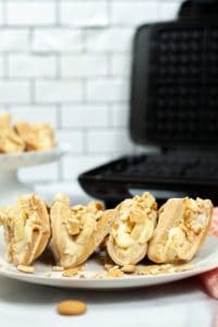 4 banana pudding tacos with waffle iron in the background