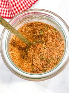 Burger Seasoning Blend in a glass jar with a spoon