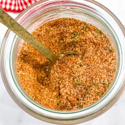 Burger Seasoning Blend in a glass jar with a spoon