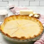Crisco Pie Crust ina glass pie dish with ingredients and a red and white stripped napkin