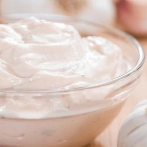 A creamy garlic aioli in a clear dish.