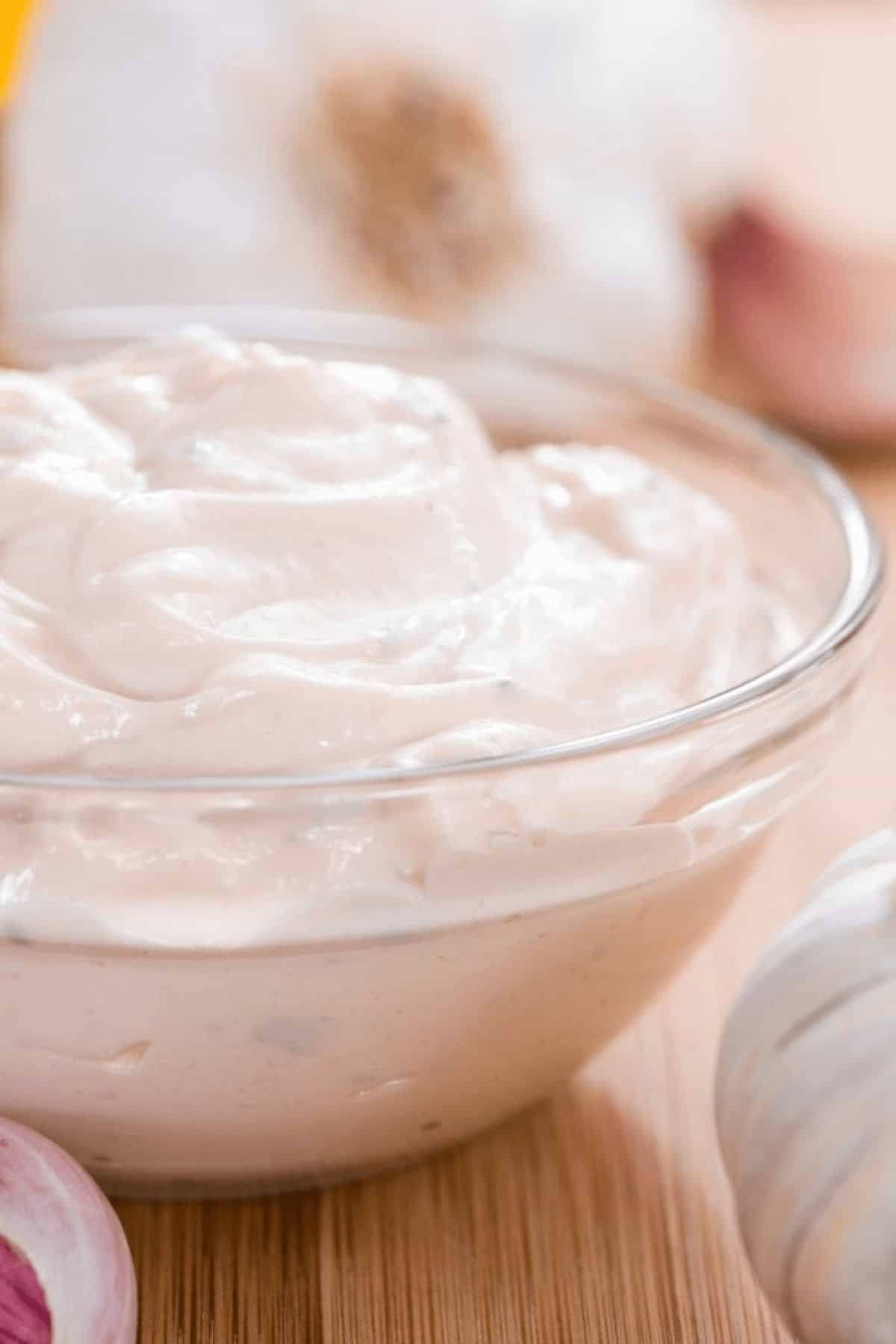 A creamy garlic aioli in a clear dish.