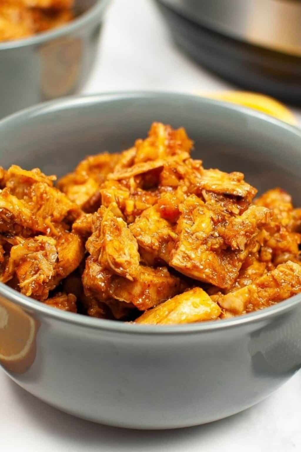 A bowl of the instant pot orange chicken in a green bowl.