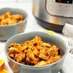 A bowl of the meal with the pressure cooker in the background.