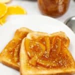 Toast with Orange Marmalade on it on a white plate