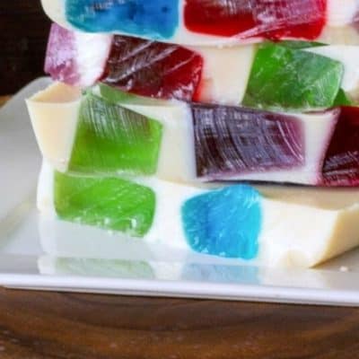 Mosaic jello stacked on a white plate