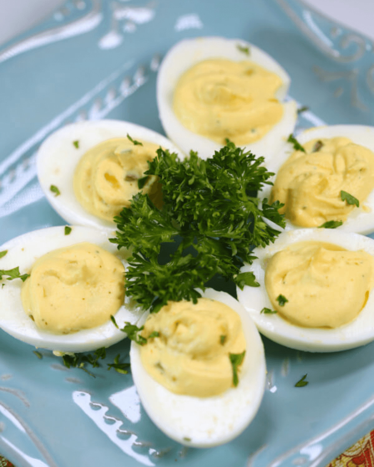 Platter of southern deviled eggs with relish, garnished with parsley.