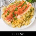A plate of Cheesy Chicken Broccoli and Rice Casserole garnished with chopped parsley, with a fork and fresh herbs in the background.