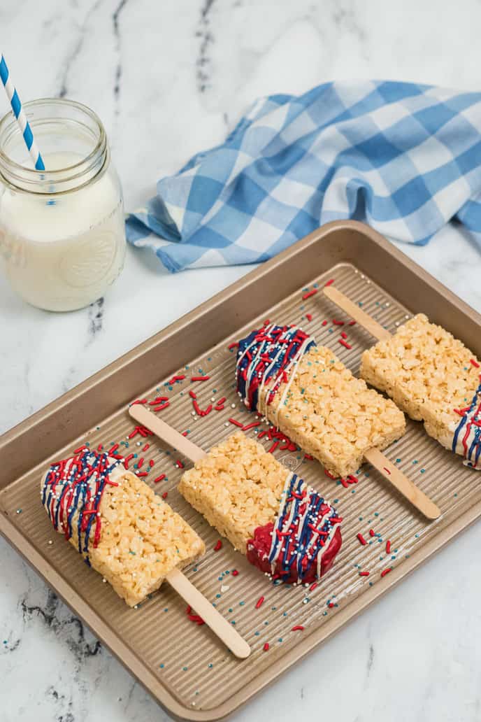 Baking tray lined with 4 Rice Krispie Treat Pops.