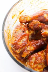 Glass bowl filled with honey bbq wings