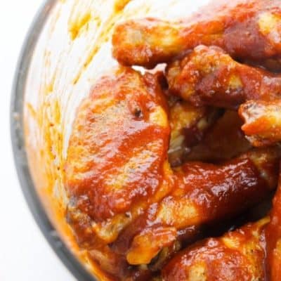 Glass bowl filled with honey bbq wings