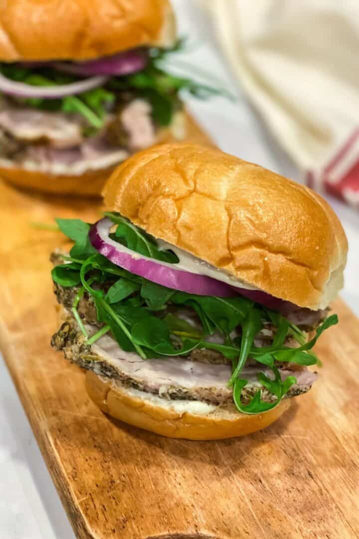 Porketta roast sandwich on a wooden board.