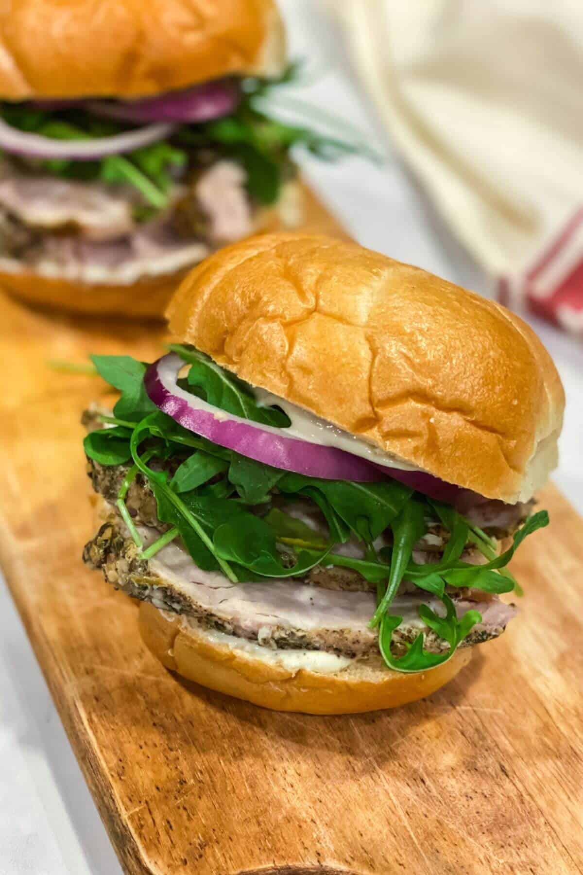 Porketta roast sandwich on a wooden board.