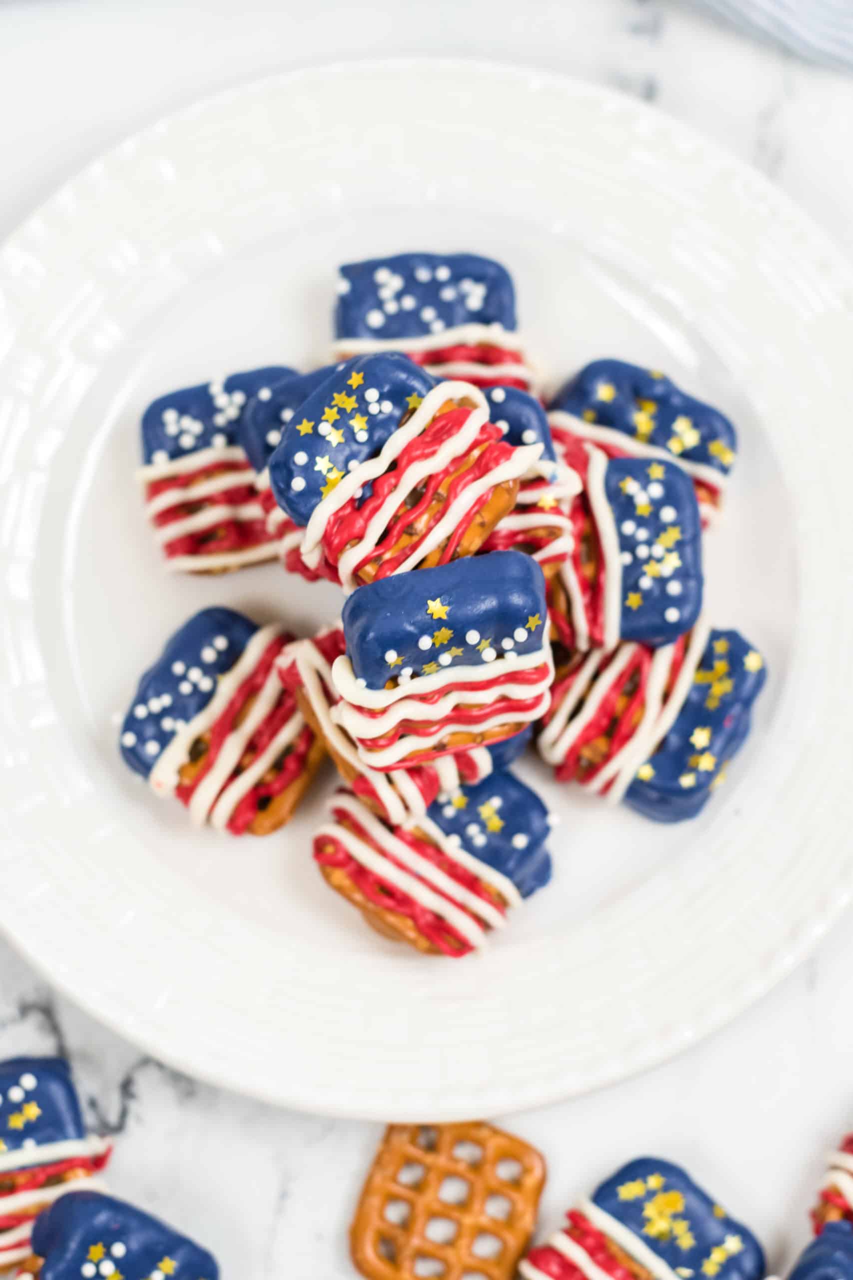 Stack of American Flag Pretzels with a scattering of them on the side.