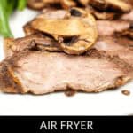 Juicy slices of ribeye steak, perfectly cooked in the air fryer, are topped with savory mushrooms and paired with fresh greens. "Air Fryer Ribeye Steak and Mushrooms" elegantly graces the bottom of the plate's presentation.