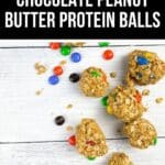 Seven Chocolate Peanut Butter Protein Balls with colorful candy pieces are scattered on a white wooden surface. Text label at top reads "Easy Chocolate Peanut Butter Protein Balls.