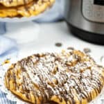 A stack of the desserts drizzled with chocolate.