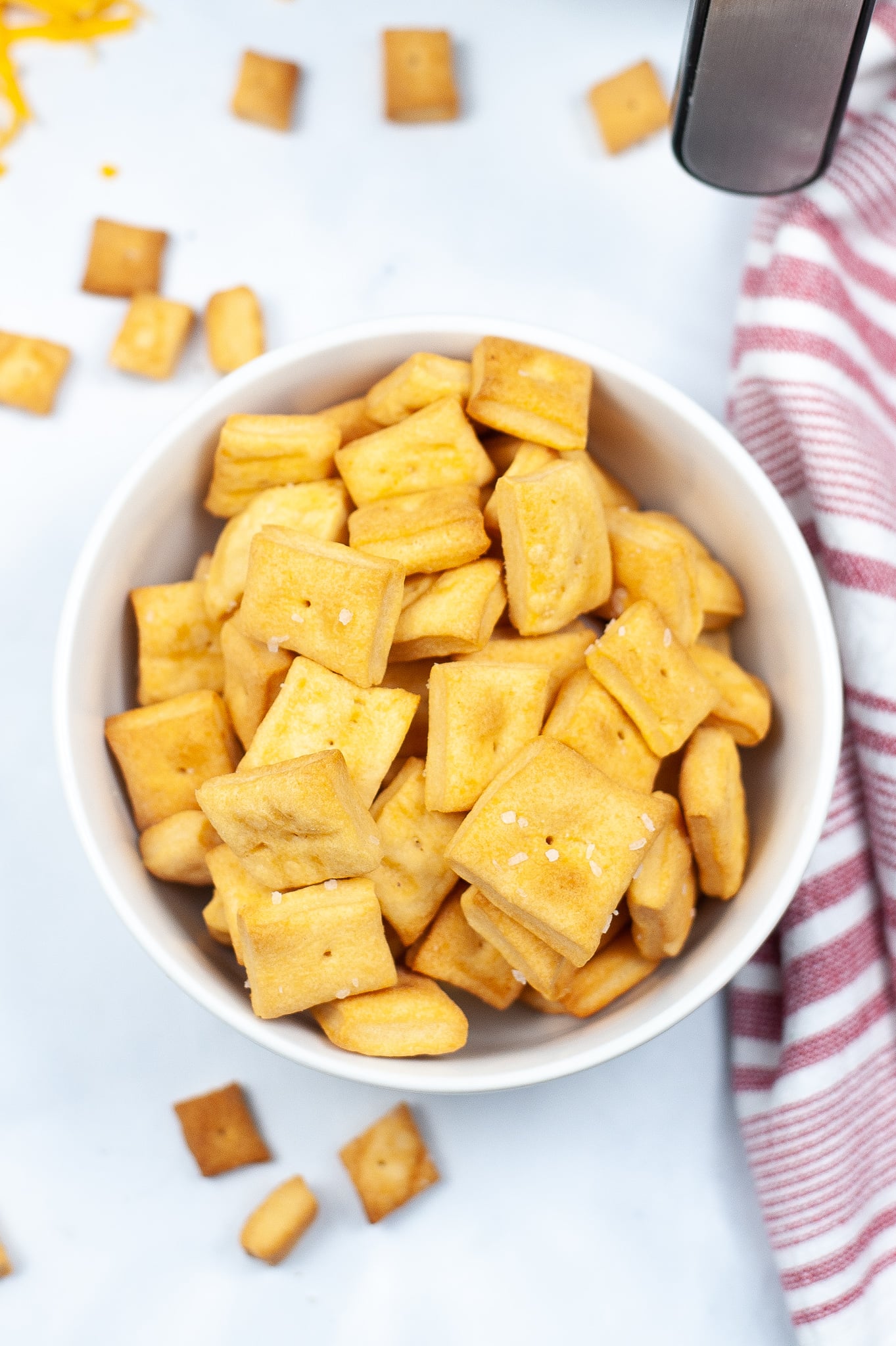 Shot of cheez its from the top in a white bowl.