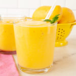 Closeup on a glass of mango smoothie.