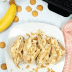 A top shot of the dessert on a white dish surrounded by cookies.