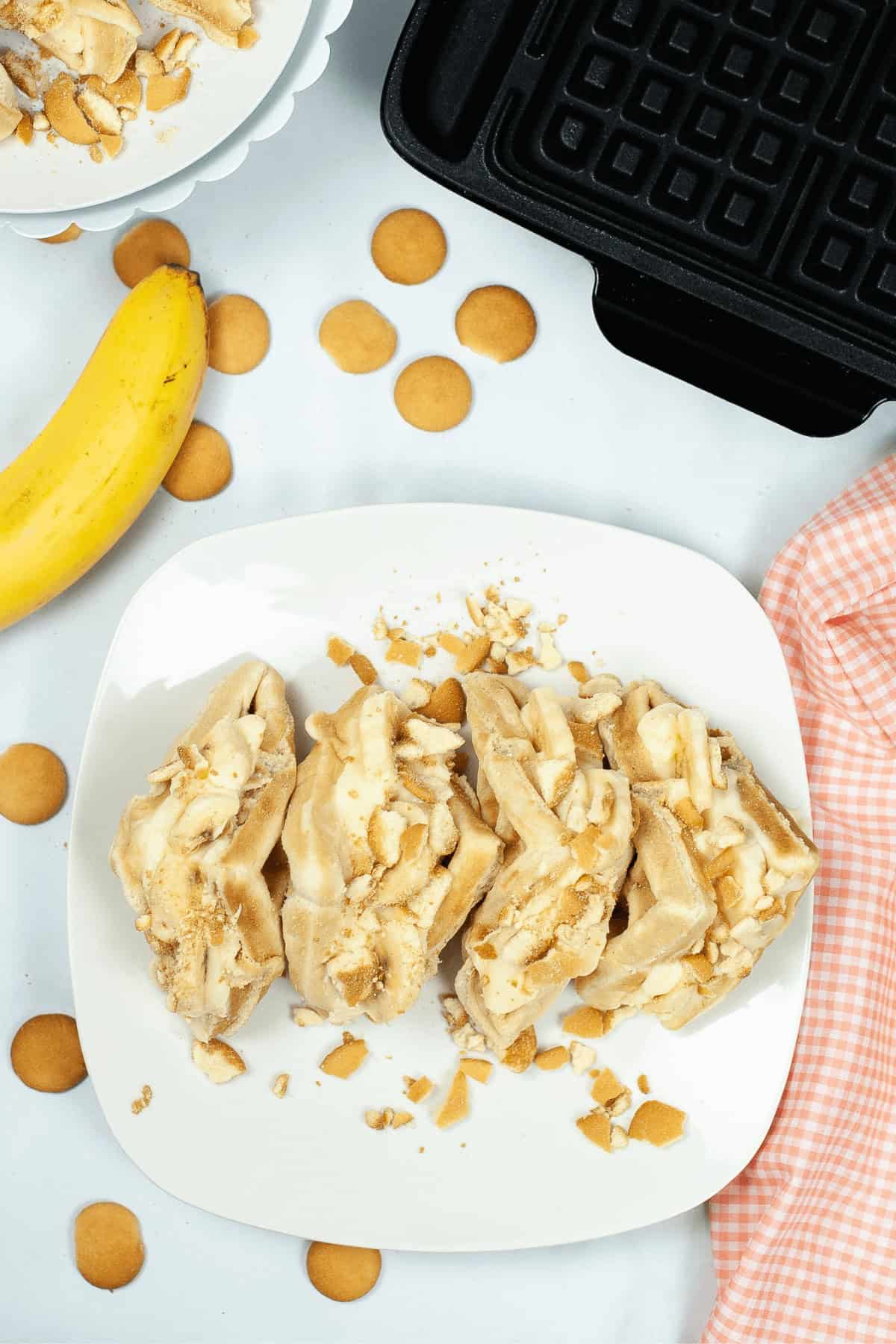A top shot of the dessert on a white dish surrounded by cookies.