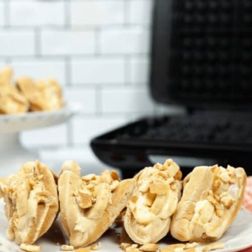 A closeup of a plate of banana tacos next to a waffle iron.