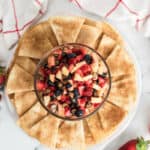 A glass bowl of vibrant appetizer with crispy cinnamon sugar tortilla chips.