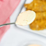 In n Out Sauce in close up on a spoon with chicken strips underneath.