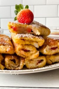 Stack of Strawberry French Toast with a Strawberry on Top.