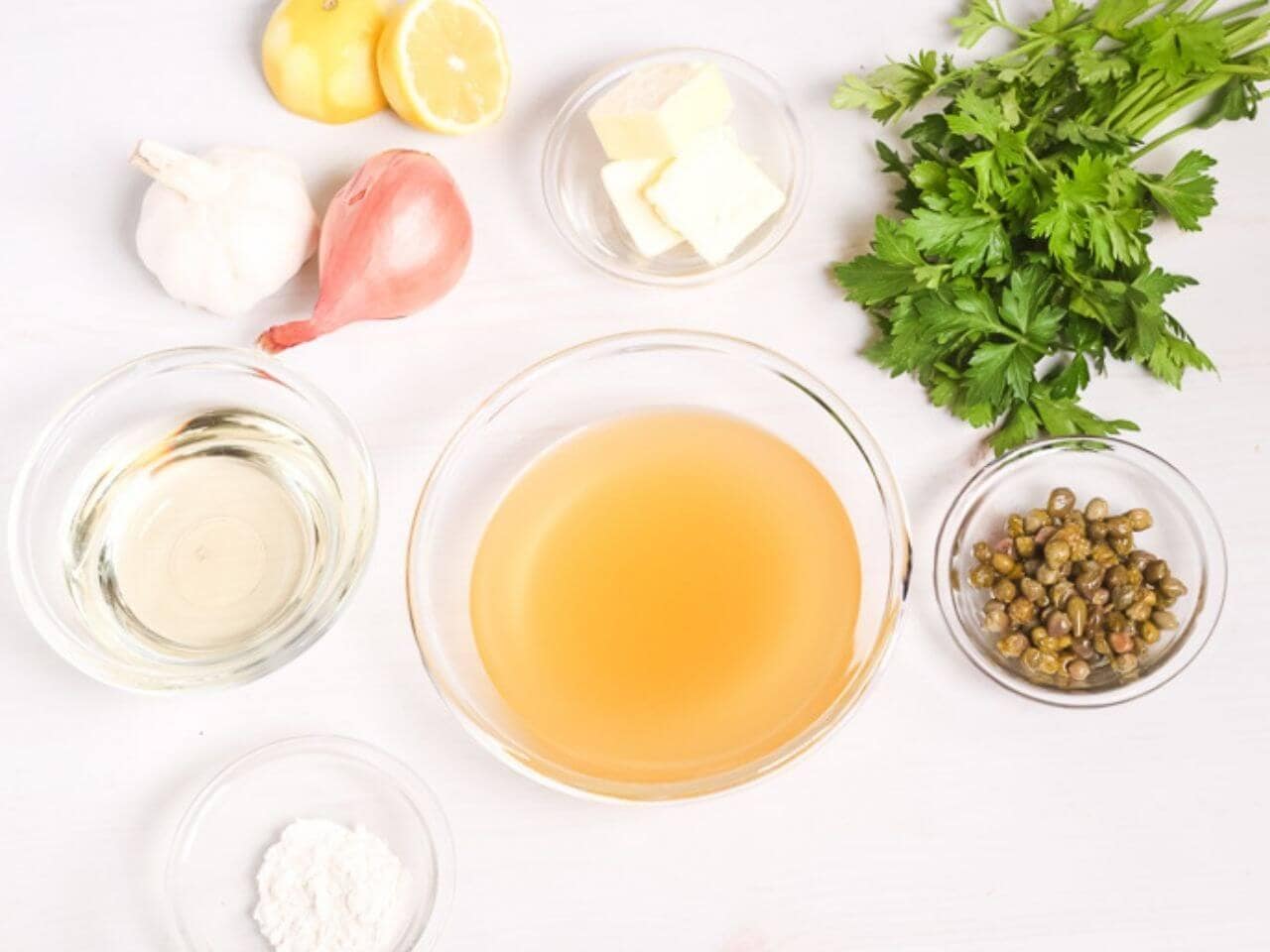 The meat, herbs, and sauce ingredients to make the dish.