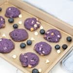 Cookie sheet with blueberry white chocolate cookies with blueberries and chips.