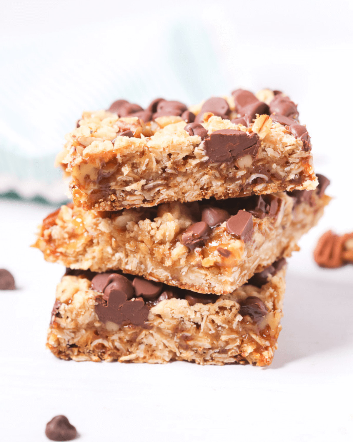 A stack of caramel chocolate oat bars with chocolate chips.