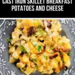 A cast iron skillet breakfast features golden potatoes topped with melted cheese and fresh herbs, served on a decorative gray plate.