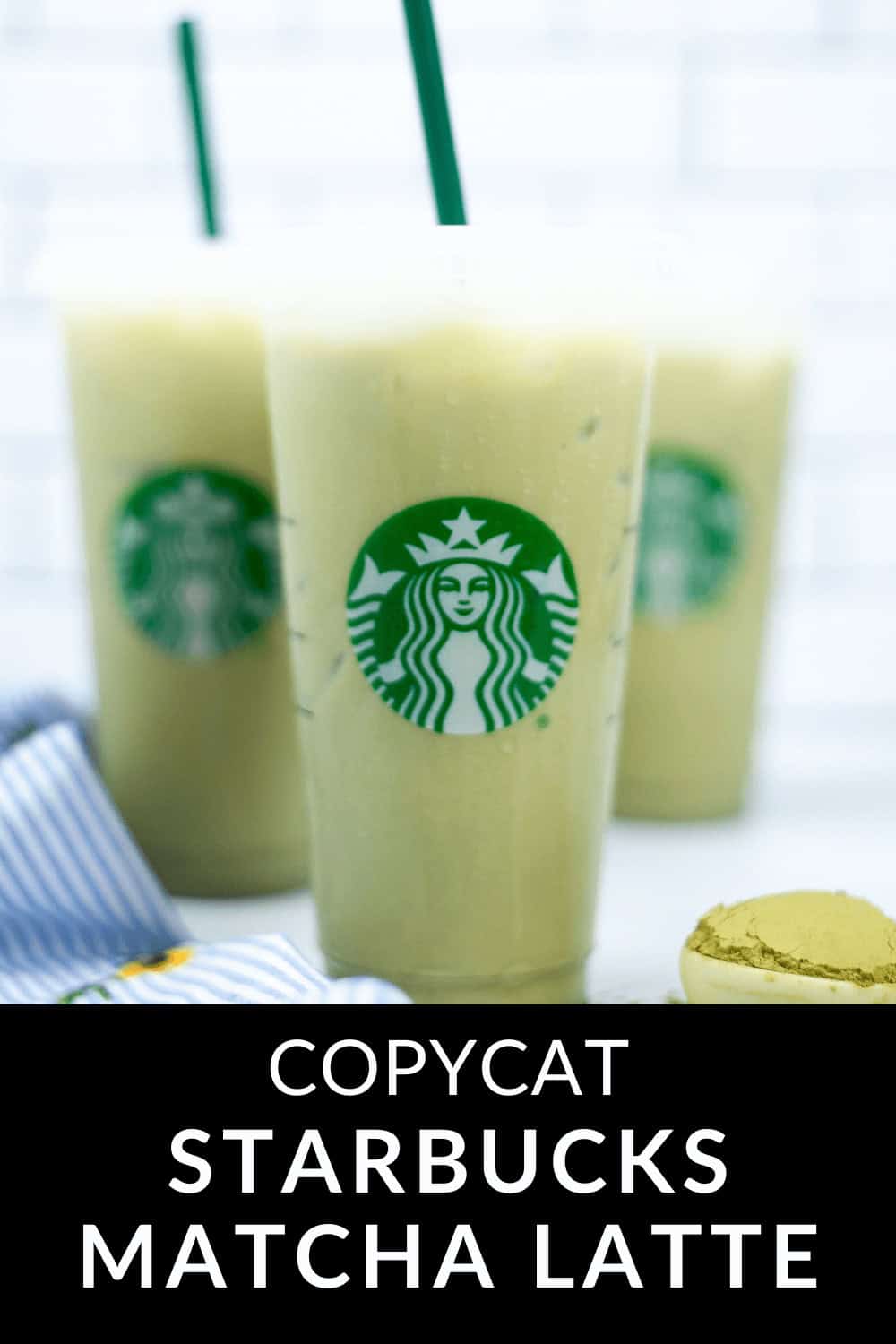 Three iced matcha lattes in Starbucks cups are artfully placed on a surface, with a small dish of vibrant matcha powder nearby, capturing the essence of this refreshing beverage.