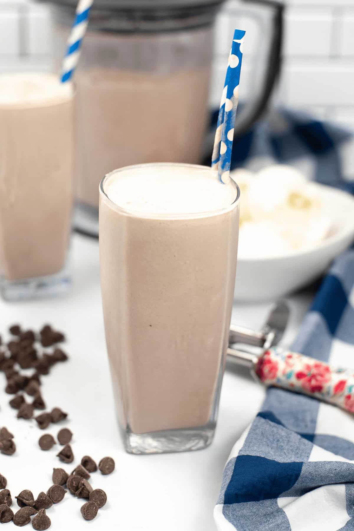 A frosty next to a blender.
