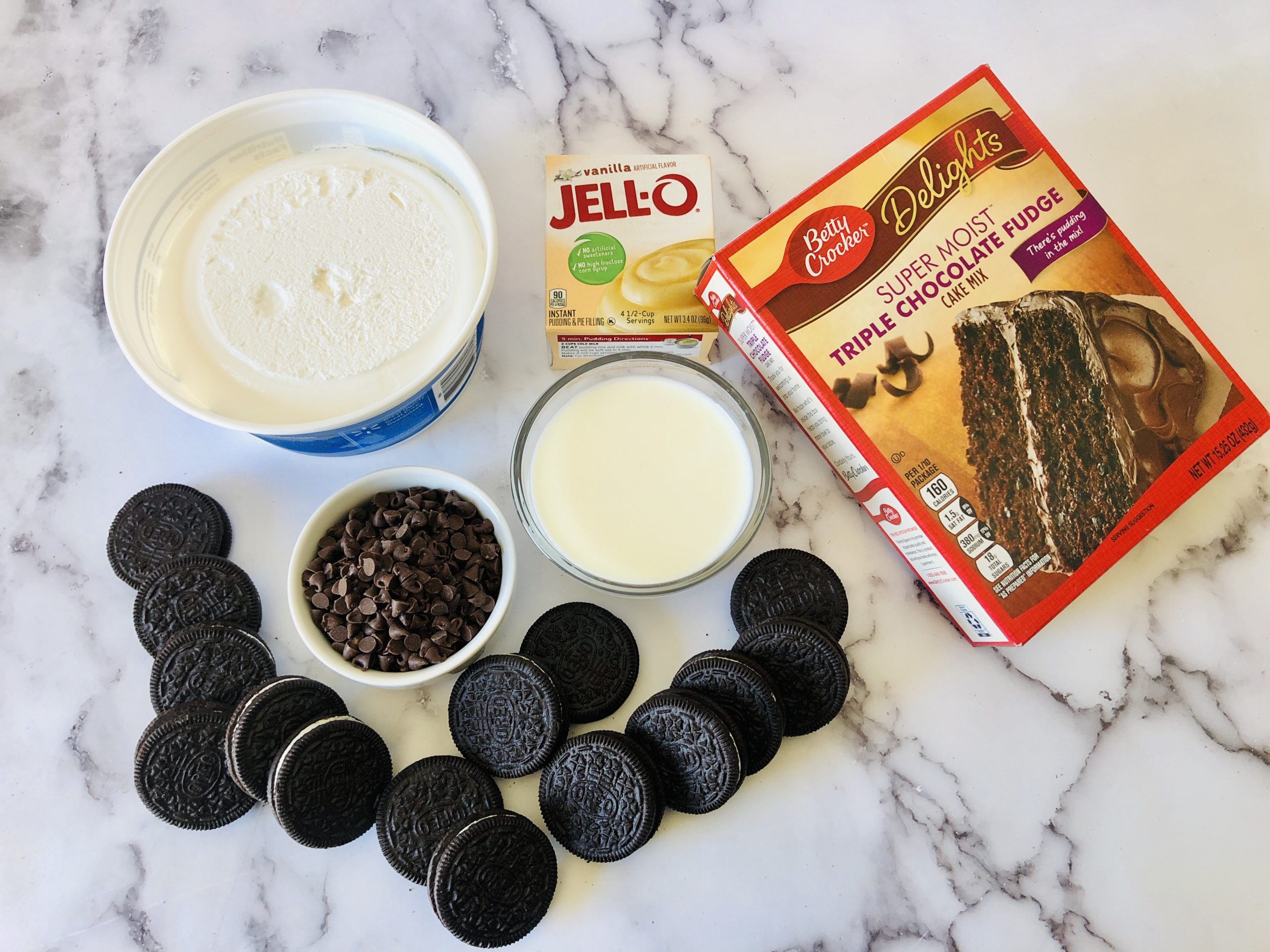 Box cake mix, oreos, pudding and ingredients for cake.