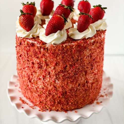 Strawberry Crunch cake on a cake stand.
