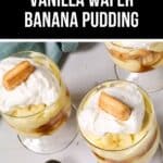 Three glasses of easy banana pudding with vanilla wafers are topped with whipped cream and a wafer, elegantly arranged on a white surface, accompanied by two golden spoons.