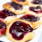 Close up of a plate of cherry danish.