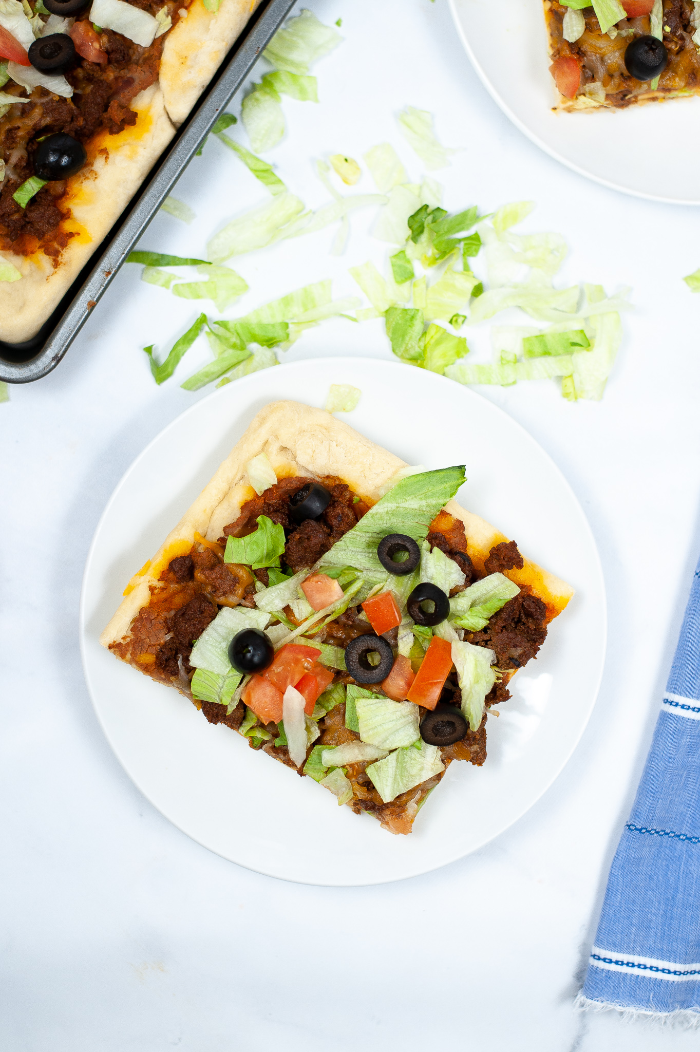 Picture showing the top slice of a sheet pan taco pizza.