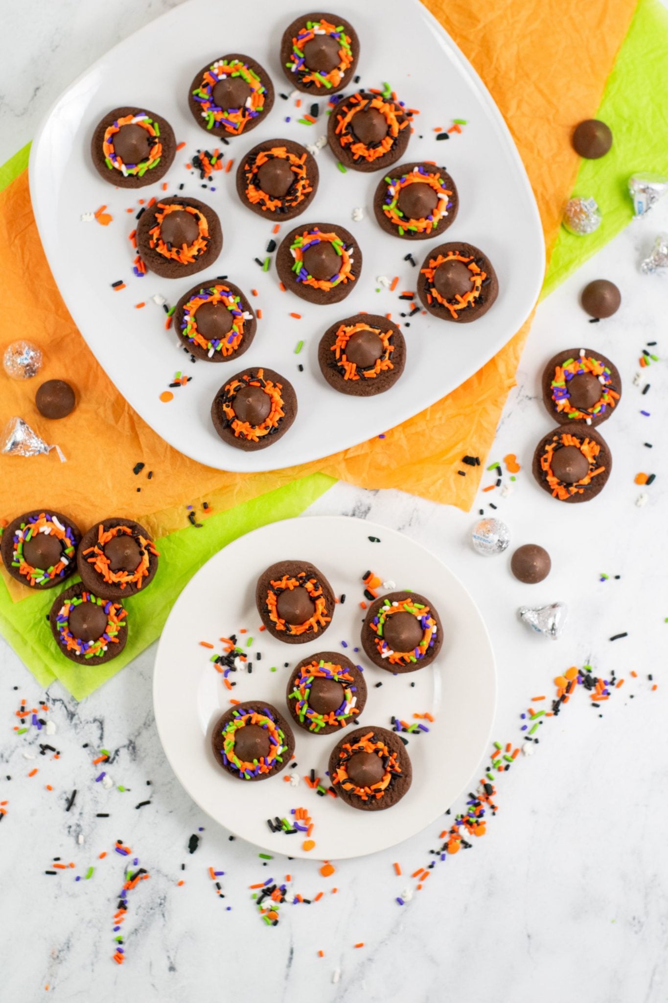 White plate and platter of Witch Hat Cookies .