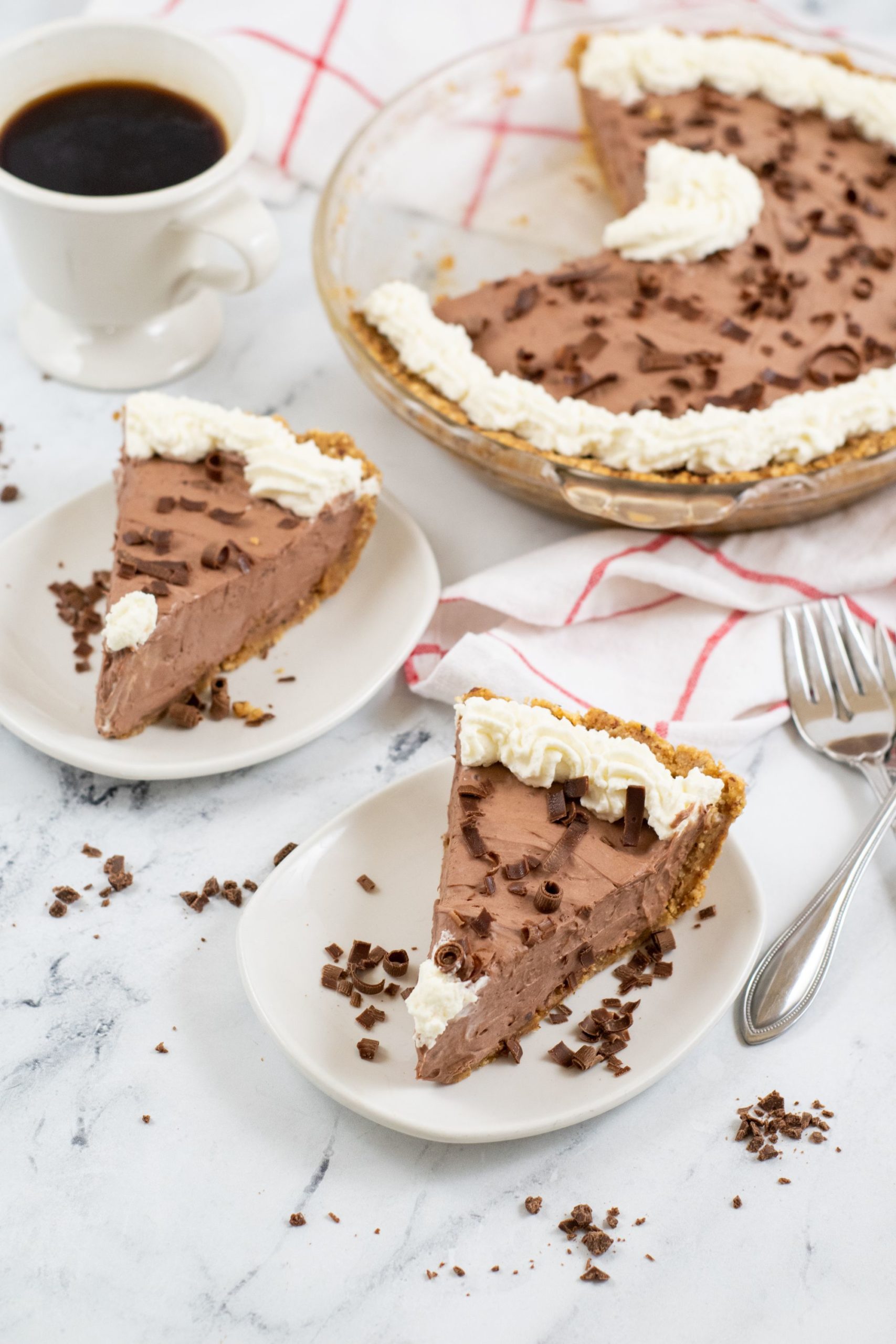 Chocolate Jello Pudding Pie with two slices on white plates.
