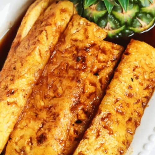 Tangy grilled pineapple on a white dish.